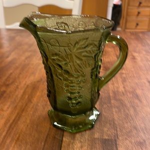 Vintage Mid Century Mod Green Glass Pitcher with textured grape vine pattern.